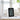 Air quality monitor with digital display on a table in a room with plants